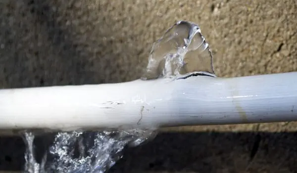 Water spraying from a burst pipe against a wall in a Southwest Fort Worth home