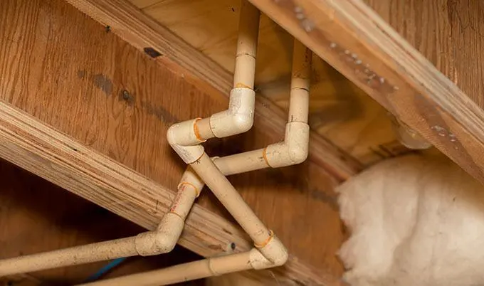 Exposed attic supply lines that split during a hard freeze in a Southwest Fort Worth home
