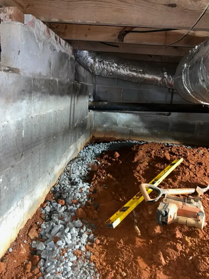 A pipe exposed under a concrete slab foundation during a Southwest Fort Worth slab leak repair